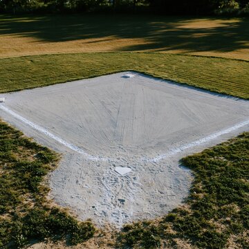 Baseball diamond infield with raked sand and chalk lines shown in a high angle view for community sports and recreation content