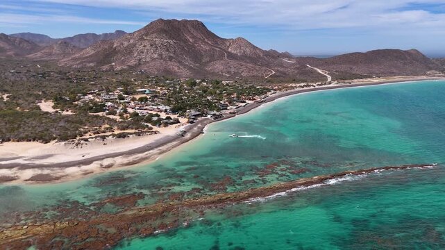 Aerial View of Cabo Pulmo Coastal Village and Coral Reef in Baja California Sur, Mexico in a sunny day, Horizontal orbit drone shot