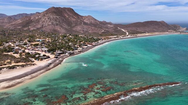 Aerial View of Cabo Pulmo's turquoise water beach and Coral Reef in the Sea of Cortez, Baja California Sur, Mexico, Horizontal backwards drone shot taken in a sunny day