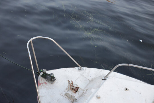 White boat floats on calm, dark water