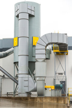 Canada, BC, Delta.  Industrial building.  Exterior ductwork and storage silos.