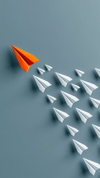 Leadership in Flight: A vibrant orange paper airplane leads a fleet of white paper airplanes in formation, symbolizing guidance and the power of innovation.