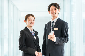 Fototapeta premium Businessmen and businesswomen (hotel staff, concierges, cabin crew) talking on their smartphones.