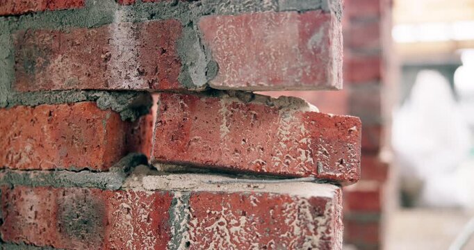 Construction, wall and loose brick at incomplete site, building development and safety hazard. Masonry, mortar and weak structure with engineering damage, danger and fail risk with architecture