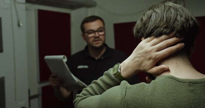 Employee listening to feedback while a supervisor points out errors and discusses work performance during a professional meeting.