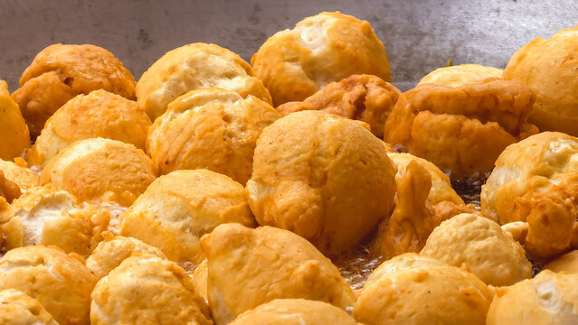Golden Brown Fried Meatball Dough Cooked in Boiling Hot Oil at Close Range.