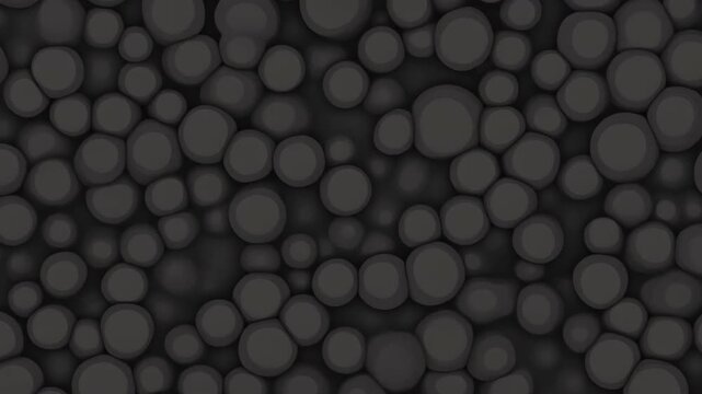 A seamless looping 3D animation featuring abstract dark grey, ebony mud or pebble-like spheres compressing and dispersing