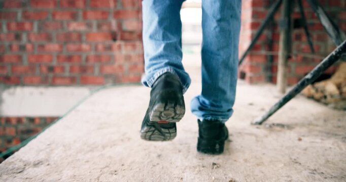 Construction, walk or legs on site with inspection, safety check or quality control in building project. Back, man or engineer with renovation, progress track or evaluation in industrial compliance.