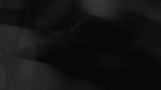 Abstract black silk fabric moving in slow motion dark background