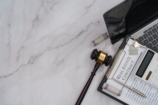 Real estate contract with gavel laptop and keys for property auction concept