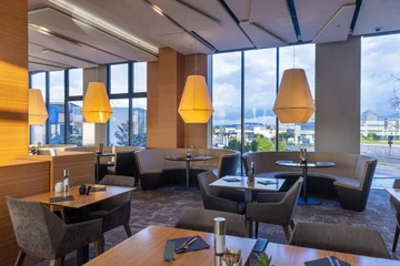 Fotobehang Horeca Modern restaurant dining room interior with round booths and city view  © rilueda
