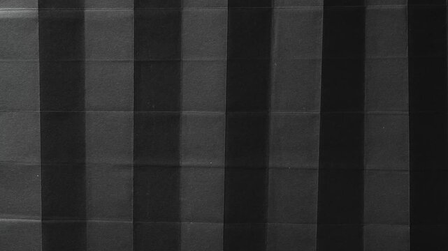 Folded Black Paper with Vertical Accordion Pleats abstract