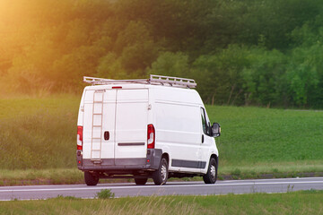 Commercial contractor van with ladders and cargo © AlexGo