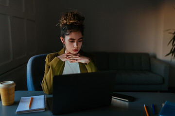 Woman working on laptop, focusing on work