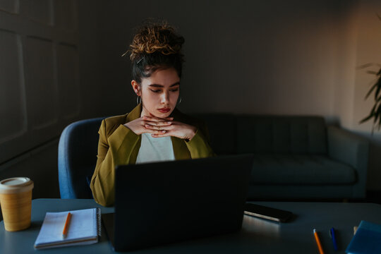 Woman working on laptop, focusing on work