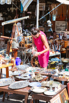 Woman browsing at a flea market in the center of Athens, Greece