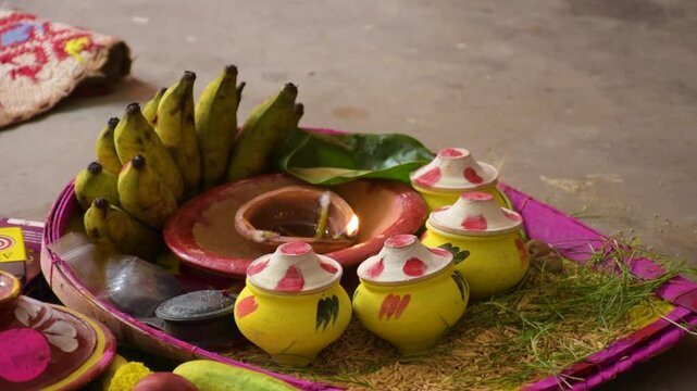 Traditional Hindu Puja Items on Bamboo Dala with Sacred Oil Lamp Flame
