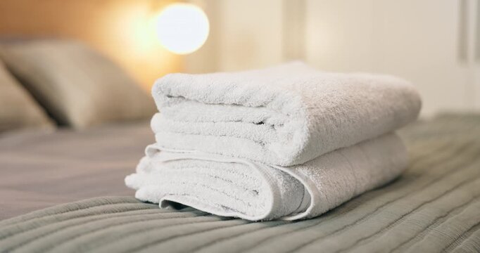 Hands, woman and clean laundry at hotel room, fresh linen and housekeeping for hygiene. Cleaner, towels and cleanliness at resort for neat arrangement, sanitation service and chores for hospitality