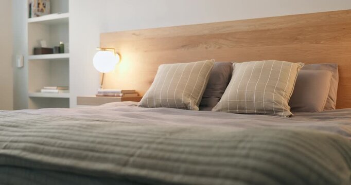 Interior, clean and bedroom at house with pillows, fresh linen and furniture for hygiene. Empty room, bed and neat bedding in home for housekeeping, cleanliness and tidy duvet with comfortable fabric