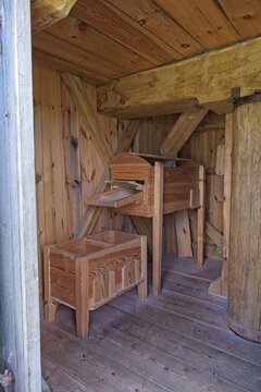 Traditional wooden grain sifter or bolter and its collection bin inside an old mill, Estonia, Europe.