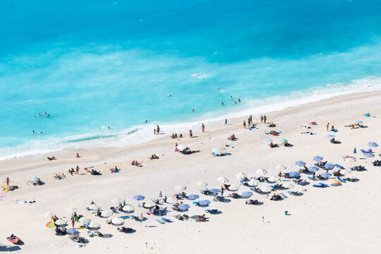 Aerial view of famous Myrtos beach with umbrellas, Kefalonia, Greek Islands, Greece