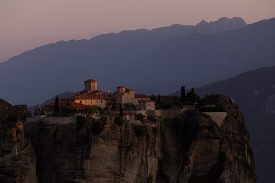 Meteora monastery on a cliff at sunset
