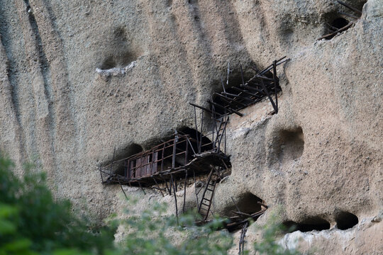 Ancient wooden hermitage built into a cliff face
