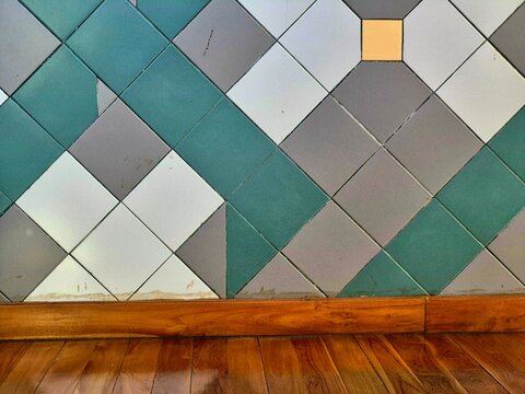 Vintage geometric tiled wall with wooden floor skirt and parquet background