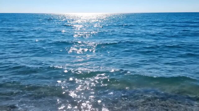 The sea is sparkling in the sun, the sea is sparkling with waves
