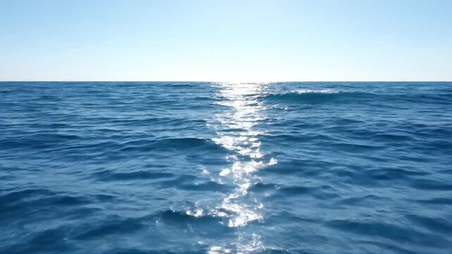 The sun shines on the landscape and the sea is sparkling