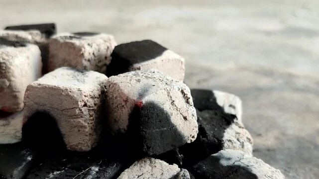 Burning charcoal briquettes with white ash. Made from renewable biomass waste and produces little ash