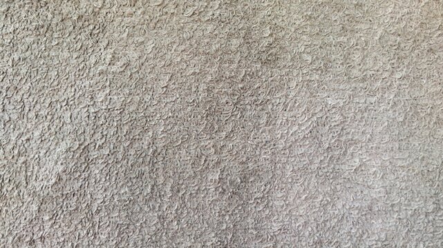 ​Close-up of beige terry cloth towel texture background