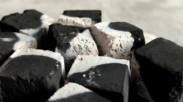 Burning charcoal briquettes with white ash. Made from renewable biomass waste and produces little ash