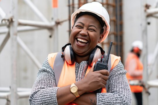 The Joyful Construction Worker On Site Wearing Helmet And Safety Vest