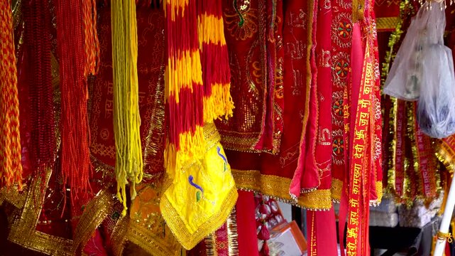  Chunris and devotional cloths with inscriptions of Jai Maa Kamakhya in the clothes at Maa Kamakhya temple market.