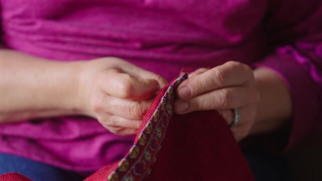 Close-Up View Of A Woman In Traditional Hand Sewing.