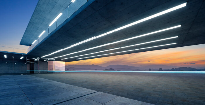 3d rendering modern futuristic architecture with empty concrete floor at sunset