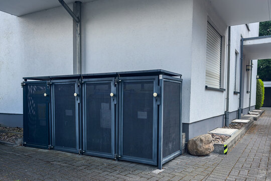Storage area near building features metal bins for waste disposal