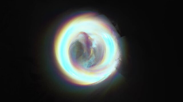 A holographic sphere of liquid energy with a rainbow halo effect. Mystical glowing magic portal and rotating ball animation.