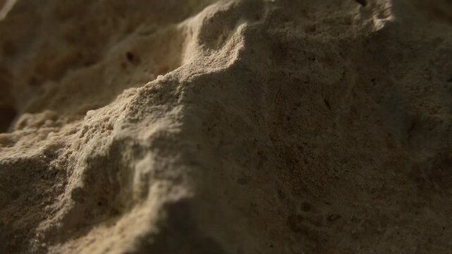 Slow tracking shot across weathered stone relief