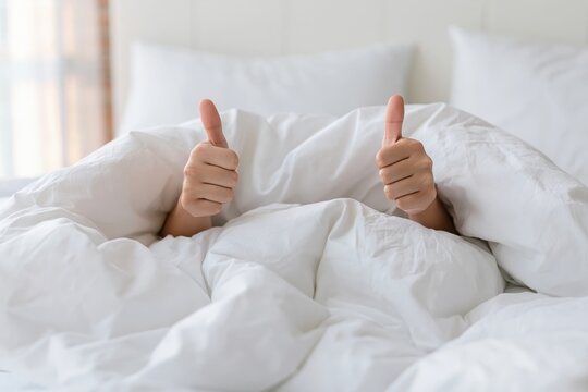 The Bed Thumbs Up in White Bedding Signaling Comfort and Relaxation