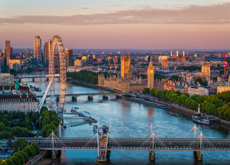 Obraz premium Aerial view of the skyline of London, England, with Southbank and Embankment, Westminster Palace during a golden summer sunrise