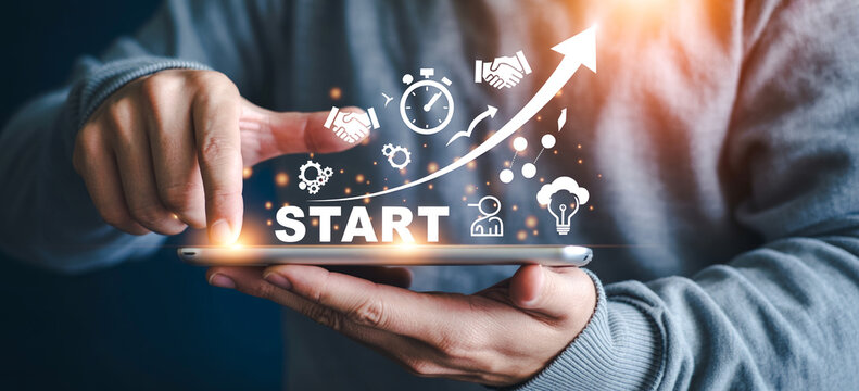 Professional hands showing digital start button and business growth charts on tablet screen.