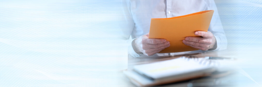 Businessman holding a folder; panoramic banner