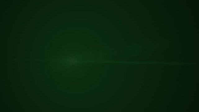 Abstract green lens flare light effect with hexagonal bokeh over dark background
