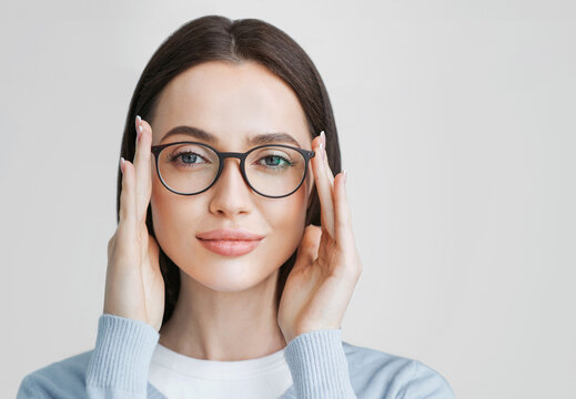 Young beautiful woman isolated portrait. Student girl wearing glasses closeup studio shot, Young businesswoman smiling indoor, People, beauty, student lifestyle, business concept