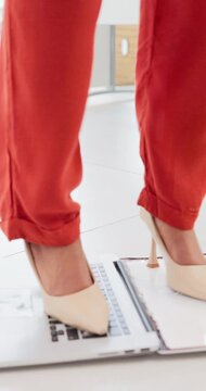 Destroy, laptop and feet of business woman with glitch, anger and frustrated for online error. Stress, office and person with computer for damage, smash and crush for problem, crisis and disaster