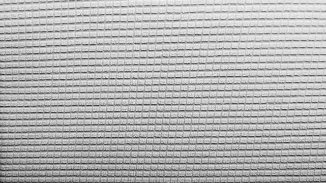 waffle texture fabric shifts color through neon pink blue violet red and white in a hypnotic macro tracking shot