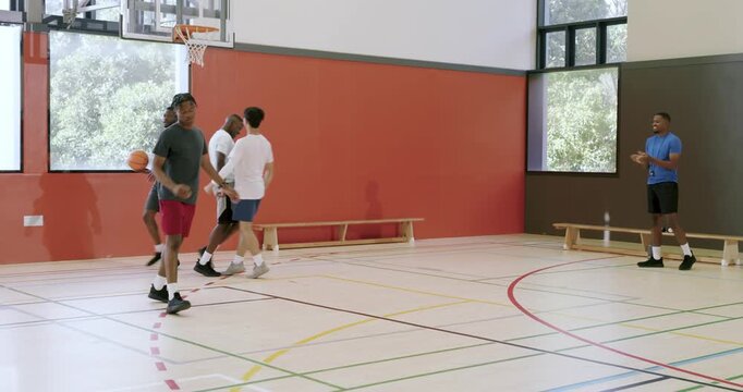 Catching basketball pass, shooting jumper, laying in and pick-and-rolling by diverse men