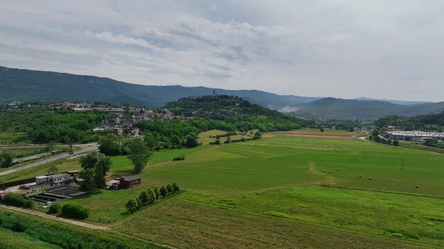 Aerial drone view of Buzet historic medieval town in Istria Croatia at early summer showing old stone buildings, hilltop settlement, surrounding forests and green valley landscape